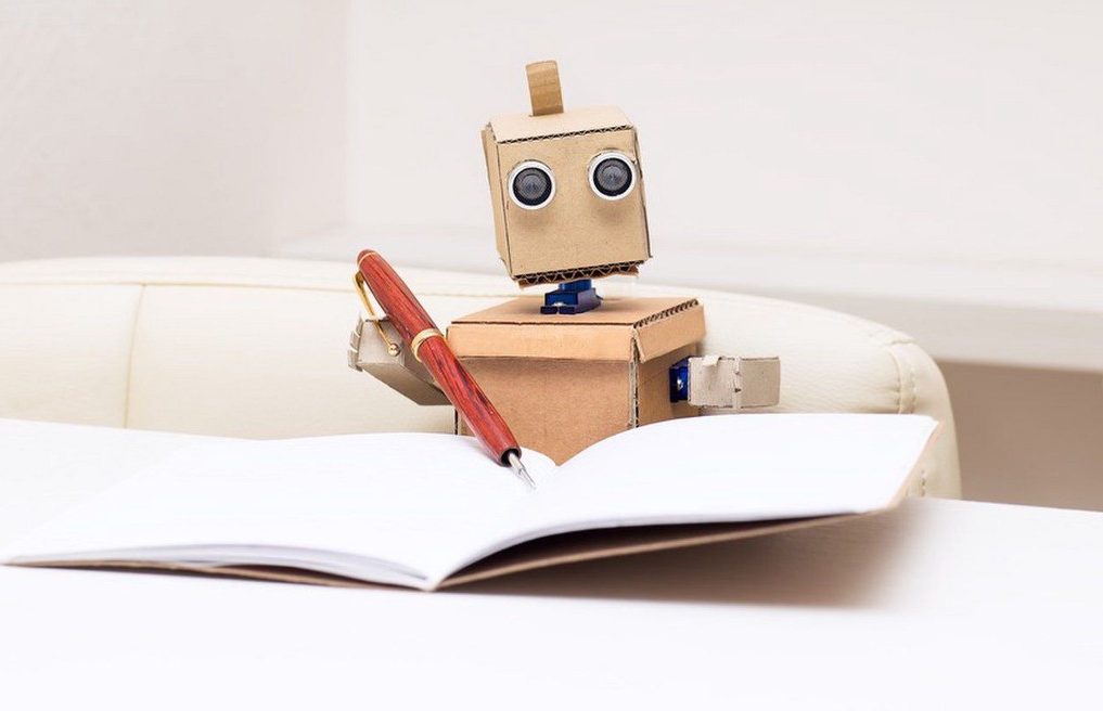 Internet Marketing cardboard robot holding a pen