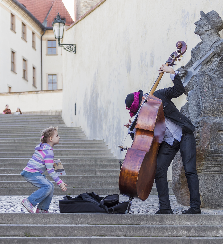 man playing cello on steps