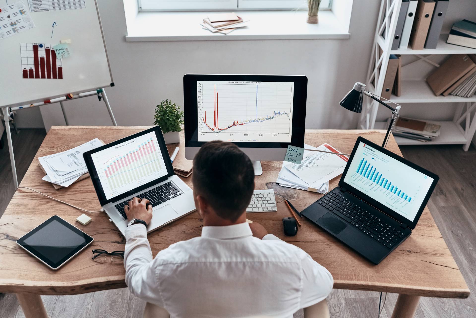 marketing sales attribution man working with three computers in office