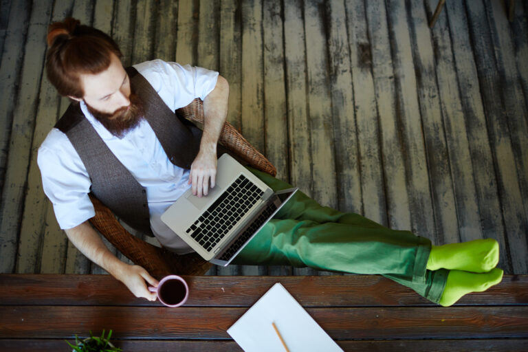 marketing plan man working with feet up on desk