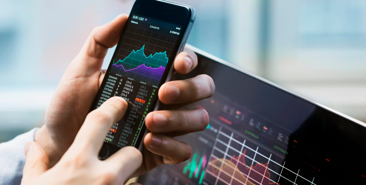 man reviewing data on a phone and tablet